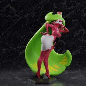 May include: A stylized figurine of a character with a green leaf-like cape and headpiece, and a pink and white outfit. The figure is posed on a black base, with a dark background.
