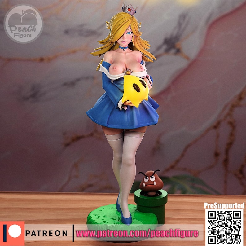 K&ouml;nnte beinhalten: Figur einer weiblichen Figur mit blonden Haaren, die ein blaues Kleid tr&auml;gt und einen gelben sternf&ouml;rmigen Gegenstand h&auml;lt. Die Figur steht auf einer gr&uuml;nen Basis mit einem gr&uuml;nen Rohr und einer braunen Kreatur. Die Figur hat eine Krone und tr&auml;gt wei&szlig;e Str&uuml;mpfe.