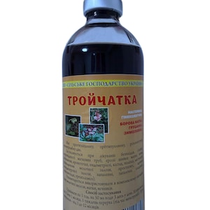 May include: A glass bottle with a silver cap, containing a dark liquid. The label, in Ukrainian, includes plant illustrations and text. The product is likely a herbal remedy or supplement.