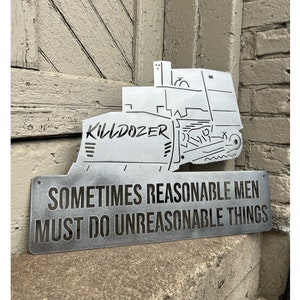May include: A metal sign with a silhouette of a bulldozer and the text "Killdozer" above the words "Sometimes reasonable men must do unreasonable things."