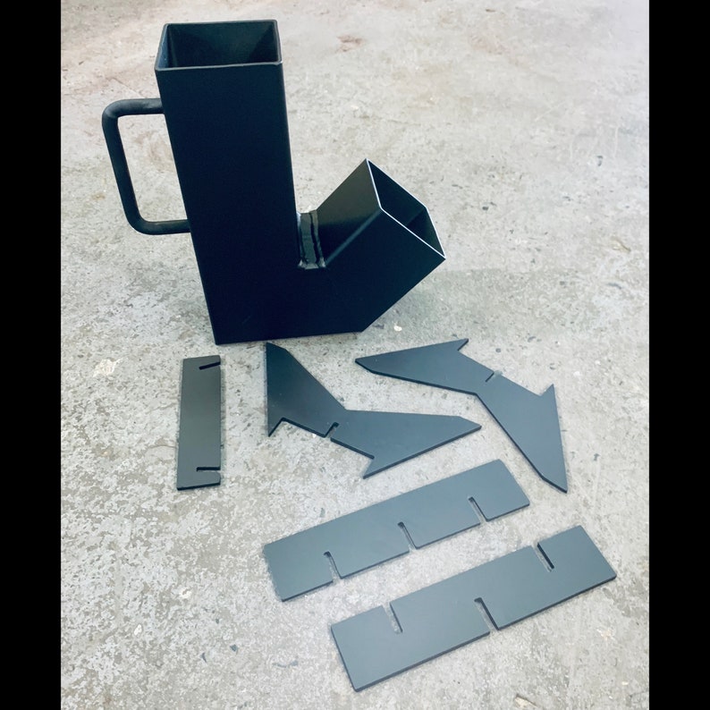 May include: A black metal wood burning stove insert with a chimney extension and a set of metal plates for installation.