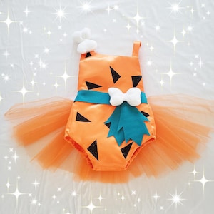May include: Orange and black costume with a turquoise bow and a tulle skirt. The costume is designed to look like a cartoon character.