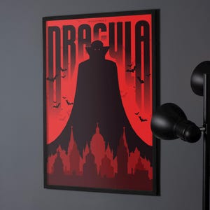 May include: A black and red poster with the title "Dracula" in bold white letters. A silhouette of a vampire with a cape stands in front of a red background with bats flying around. The vampire is standing in front of a city skyline.