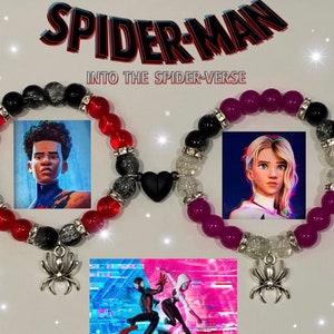 May include: Two beaded bracelets with charms featuring characters from the movie Spider-Man: Into the Spider-Verse. One bracelet has red and black beads with a black charm of Miles Morales. The other bracelet has purple and white beads with a white charm of Gwen Stacy. The bracelets are connected by a black heart charm.