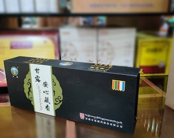 May include: A black box with gold lettering and a green design. The box is labeled "安心藏香" which translates to "Peaceful Incense". The text "西藏甘露藏药股份有限公司" is also on the box, which translates to "Tibet Sweet Dew Tibetan Medicine Co., Ltd."