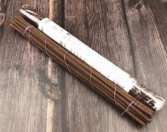 May include: A bundle of brown incense sticks wrapped in clear plastic with a white label that reads "Incense Sticks".
