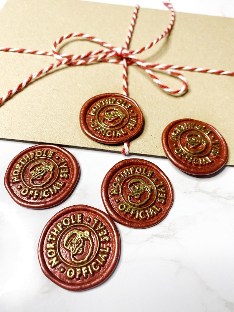 May include: Four red wax seals with gold lettering and a Santa Claus image. The seals read "North Pole Official Seal".