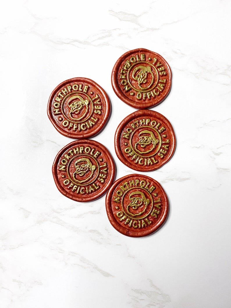 May include: Five red wax seals with gold lettering and a Santa Claus image. The seals read "North Pole Official Seal".