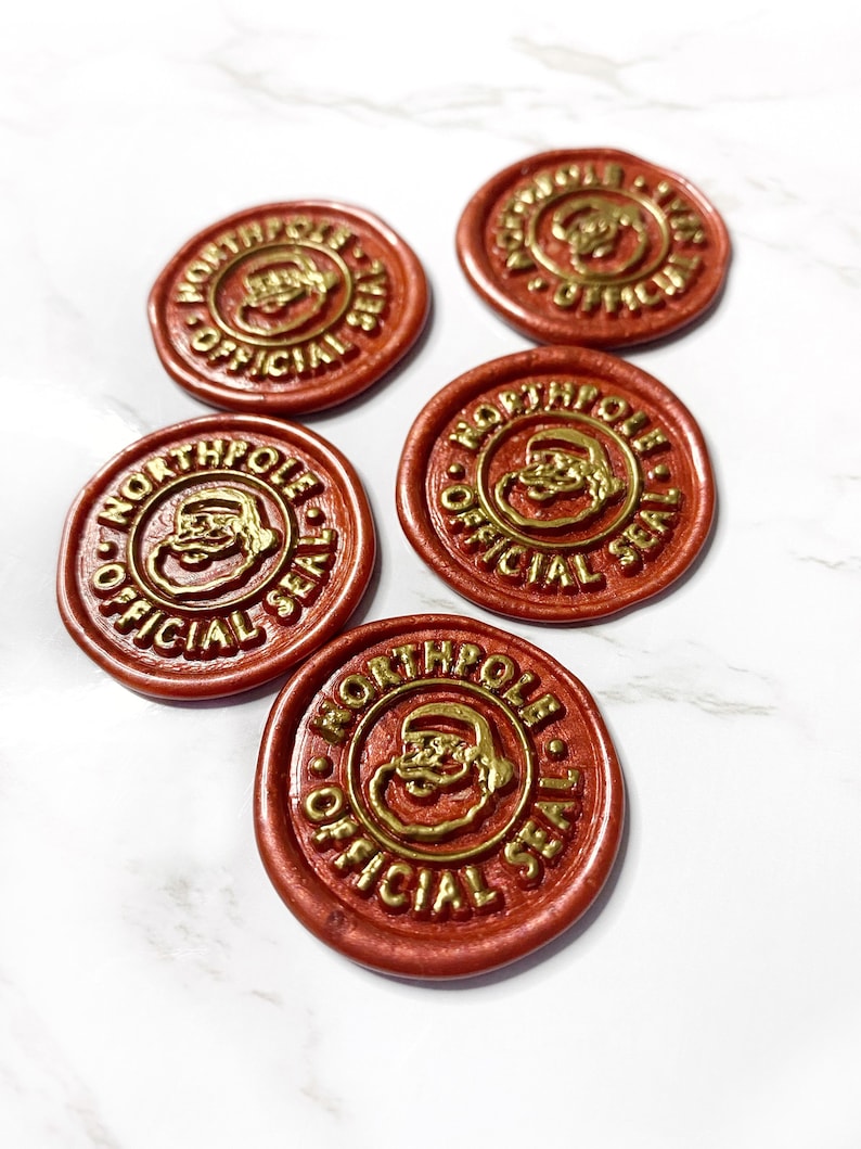 May include: Five red wax seals with a gold design of Santa Claus's face and the words "North Pole Official Seal".