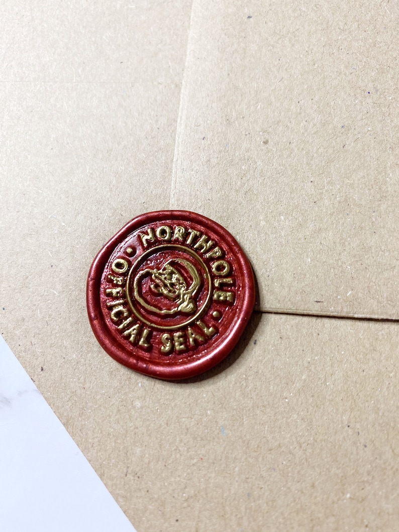 May include: A red wax seal with a gold inscription that reads "Official North Pole Seal".