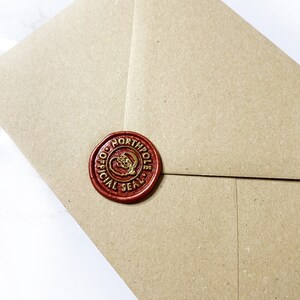 May include: A brown paper envelope with a red wax seal. The seal has a gold design and the words "Official North Pole Seal".