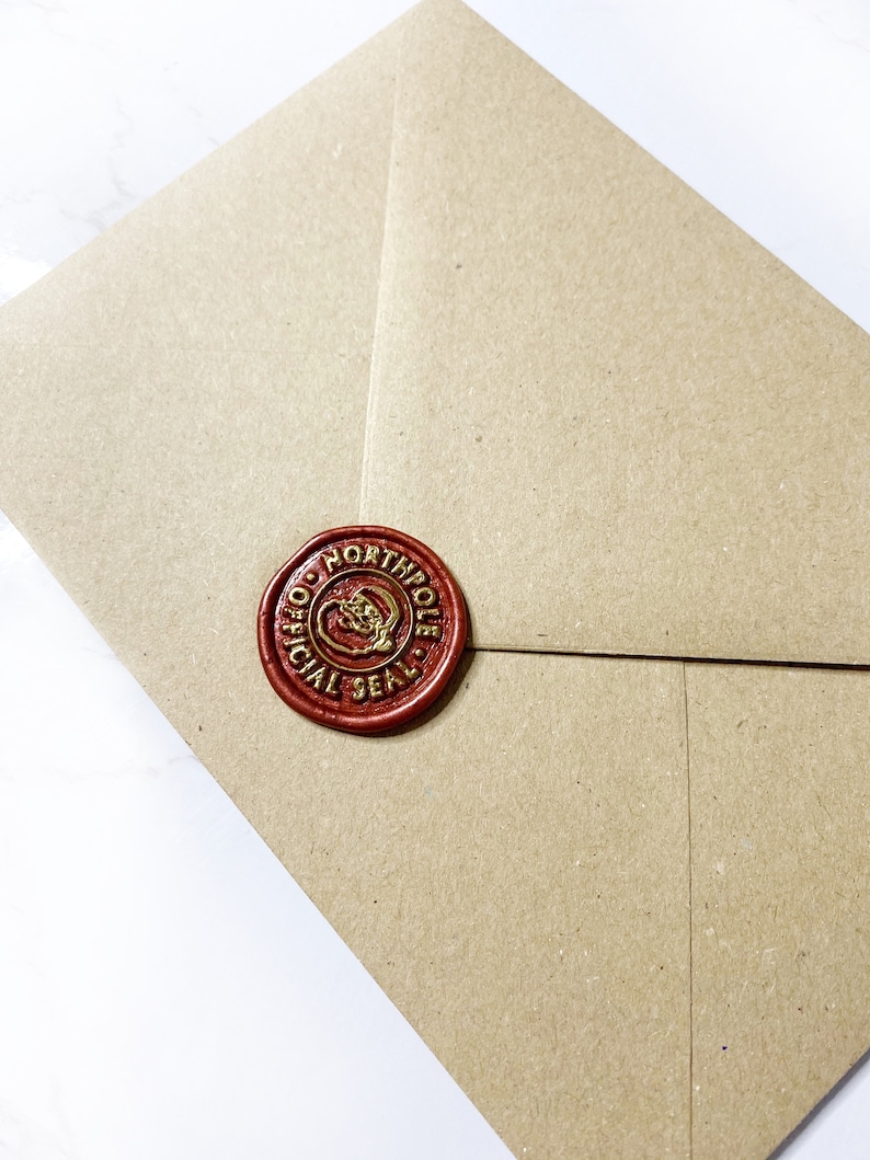 May include: A brown paper envelope with a red wax seal. The seal has a gold design and the words "Official North Pole Seal".