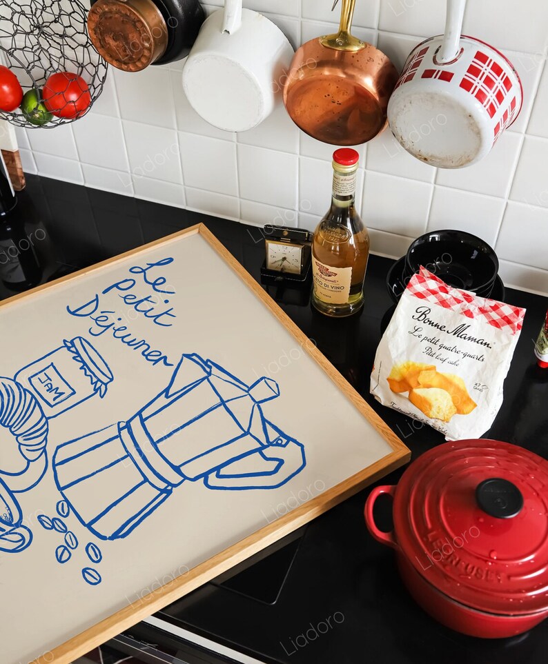 May include: A framed illustration of a coffee pot, coffee beans, and a jar of jam with the text "Le Petit D&eacute;jeuner" in blue lettering on a beige background.