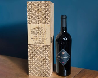 May include: A wooden wine box with a geometric pattern and a personalized message. The message reads "William & Amy 2nd March 2019 Happy 5th Wedding Anniversary Love Harry". A bottle of red wine is next to the box.