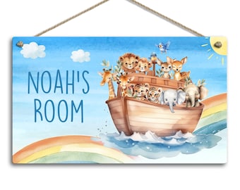 May include: A wooden sign with a blue background and a rainbow at the bottom. The sign says "Noah's Room" and features a cartoon illustration of Noah's Ark with animals on board.