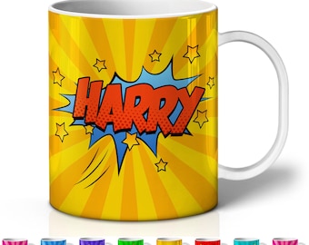 May include: A white-handled mug with a yellow background featuring a comic book style design. The word "HARRY" is in red, outlined in black, and set against a blue burst. Additional mugs with different names are shown below.