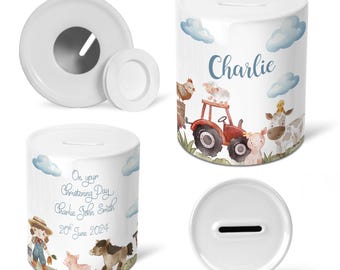 May include: White ceramic piggy bank with a watercolor design of farm animals, a tractor, and clouds. The piggy bank has a slot on the top and says "Charlie" on the front.