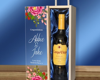 May include: A wooden wine gift box with a clear acrylic panel featuring a floral design and the text "Congratulations Abbie & Jake Love from Sarah & Steve x". The box contains a bottle of Campo Viejo Rioja Tempranillo wine.
