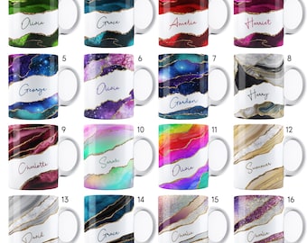 May include: Set of 16 white ceramic mugs with gold accents and agate-like designs. Each mug features a different color scheme and a name printed in gold lettering. The names include Olivia, Grace, Amelia, Harriet, George, Gordon, Harry, Charlotte, Sarah, Summer, David, Charlie, and more.