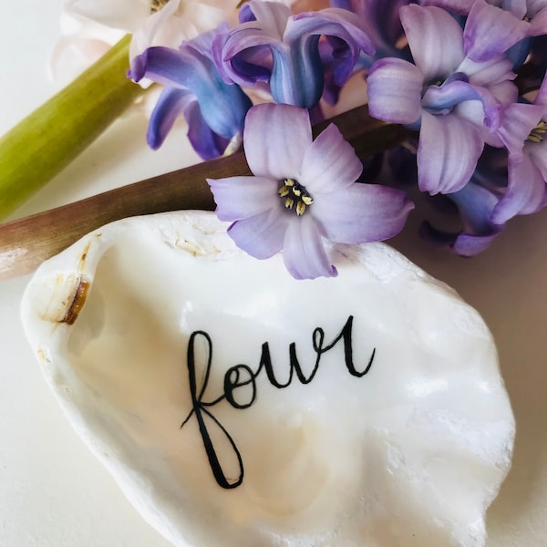 Wedding table decor and favours. Personalised Handwritten Calligraphy oyster shells for unique table settings and keepsakes.