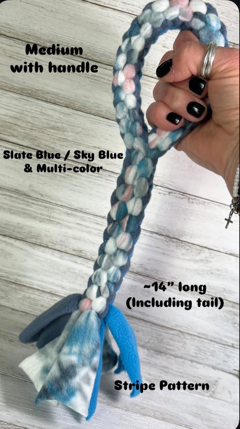 May include: A medium-sized dog toy with a handle, featuring a braided design in slate blue, sky blue, and multi-color. The toy has a stripe pattern and is approximately 14 inches long, including the tail.