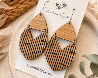 May include: Dangle earrings featuring a two-part design with a solid light wood top and a textured cork bottom with black vertical stripes. The earrings are attached to a white display card printed with the text Leannalie and Leannalie.Etsy.com.