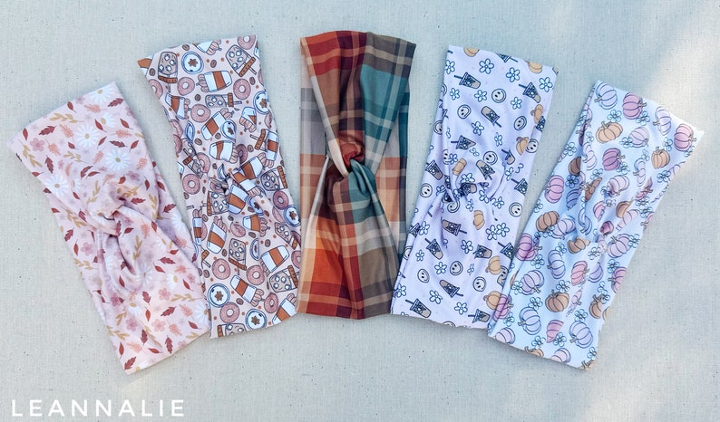 May include: Five different patterned headbands in a variety of autumn-themed prints. The headbands are made of a soft, stretchy fabric and are perfect for adding a touch of style to any outfit.