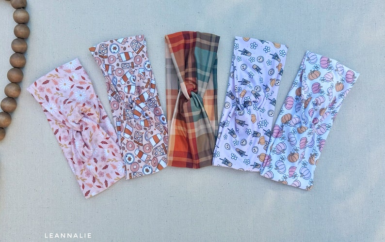May include: Five different patterned headbands in a variety of autumnal colours and designs. The headbands are made of a soft, stretchy fabric and are perfect for adding a touch of style to any outfit.