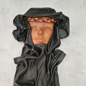 Large handmade vintage decorative wall leather mask representing the head of a Tuareg man with his black shawl, leather wall decoration