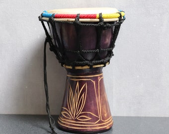 Decorative African percussion musical instrument in carved wood and original leather, old decorative Djembe, African wooden tamtam