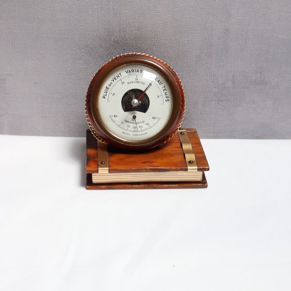 Vintage French wooden barometer weather station on a book, old decorative barometer, barometer book decoration, wooden decoration