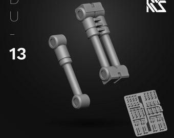 May include: A set of two gray metal hydraulic pistons with a detailed design. The pistons are part of a model kit for building a robot or other mechanical device. The kit is labeled "Hydraulics II" and is part of the HDM Hi-Definition Model series.