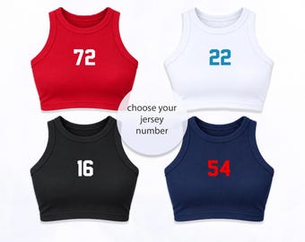 May include: Four sleeveless crop tops in red, white, black, and navy blue. Each top features a centred jersey-style number in a contrasting colour: 72 in white, 22 in blue, 16 in white, and 54 in red. Text in the centre reads: choose your jersey number.