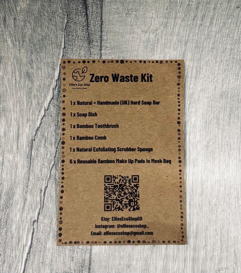 May include: A brown card with the text "Zero Waste Kit" and a list of eco-friendly products, including a hard soap bar, soap dish, bamboo toothbrush, comb, exfoliating sponge, and reusable makeup pads. The card also includes Etsy and Instagram information.