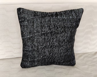 May include: Black and white patterned throw pillow with a textured woven fabric.