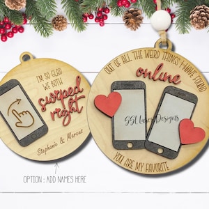 Peut inclure: Deux décorations de Noël en bois avec un design de téléphone et de cœur. L'une dit "Je suis si heureux que nous ayons tous les deux balayé vers la droite" avec des noms. L'autre dit "De toutes les choses étranges que j'ai trouvées en ligne, tu es mon préféré."