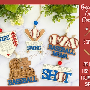 May include: Five different styles of wooden baseball car charms. The charms feature baseballs, bats, and phrases such as "Baseball Mama" and "Hit it with your best shot".