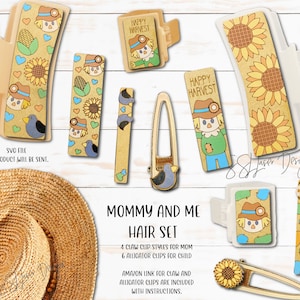May include: A set of 10 hair clips featuring a fall theme with a scarecrow, sunflowers, and hearts. The set includes 4 claw clips and 6 alligator clips. The text "Mommy and Me Hair Set" is printed on the white background. The text "Happy Harvest" is printed on two of the clips.