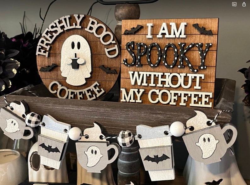 May include: A wooden sign with the text "I am spooky without my coffee" in black and white letters with white polka dots. The sign is decorated with bats and a ghost holding a coffee cup.