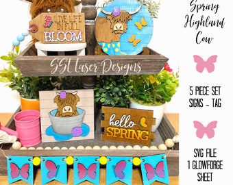 May include: A five-piece set of spring-themed wooden signs featuring a Highland cow, butterflies, and the text "Live Life in Full Bloom" and "Hello Spring". The signs are designed for a tiered tray and include a tag.