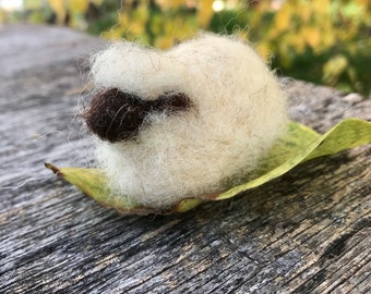 Felted sheep lying down