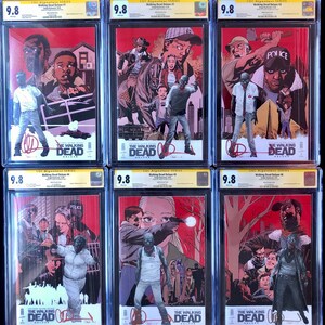 May include: Six comic books graded 9.8 by CGC in protective cases. The comic books are all The Walking Dead Deluxe issues 1-6. The covers feature various characters from the comic book series, including Rick Grimes, Michonne, and the Governor. The covers are a mix of red, orange, and yellow colors.
