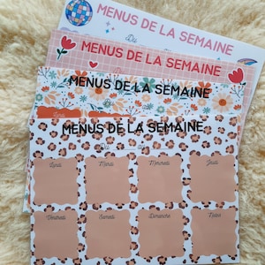 May include: A collection of weekly menu planners with diverse designs. The top planner features a disco ball graphic. Other planners display floral, heart, and leopard print patterns. Each planner has the text "MENUS DE LA SEMAINE" and spaces for daily meal planning.