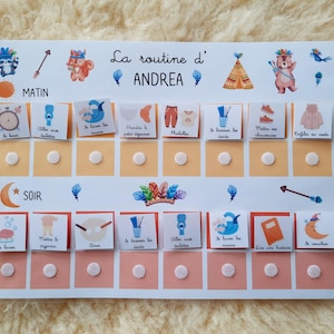 May include: A white board with a colorful routine chart for a child named Andrea. The chart has two columns, one for morning and one for evening, with a list of activities to complete. Each activity has a corresponding picture and a check box to mark when it is completed.