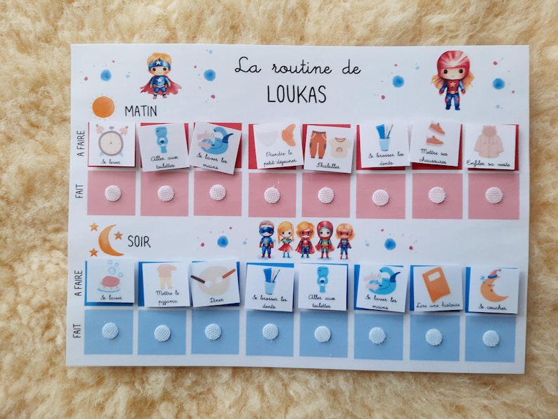 May include: A colorful chart with a superhero theme for a child's daily routine. The chart has two sections, "Morning" and "Evening", with a list of activities to complete. Each activity has a corresponding picture and a space for a sticker to mark completion.
