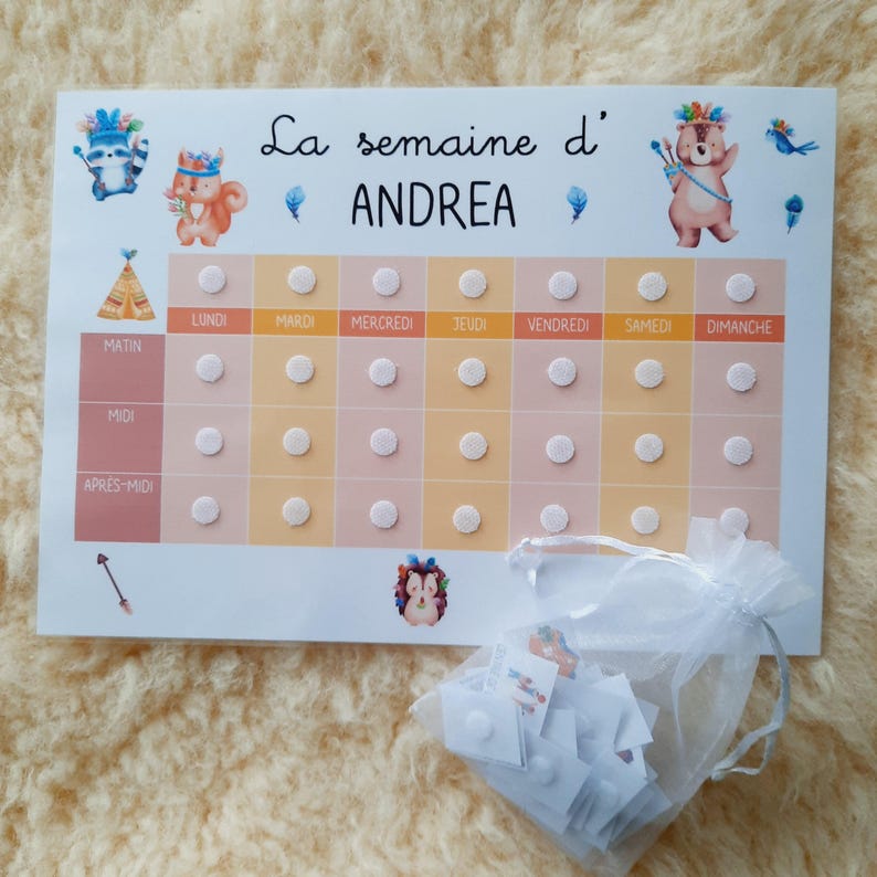 May include: A white and orange weekly chart with the text "La semaine d' ANDREA" at the top. The chart is divided into seven columns for each day of the week, with rows for morning, noon, and afternoon. There are white circles on each day of the week for marking off tasks or activities.