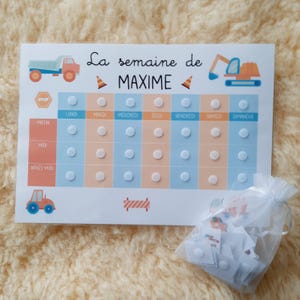 May include: A printable chart for a child's weekly schedule, featuring a construction theme. The chart has a blue and orange background with images of a dump truck, excavator, and traffic cones. The days of the week are listed across the top, and the times of day are listed down the side. There are blank circles for stickers or other markers to indicate completed tasks.