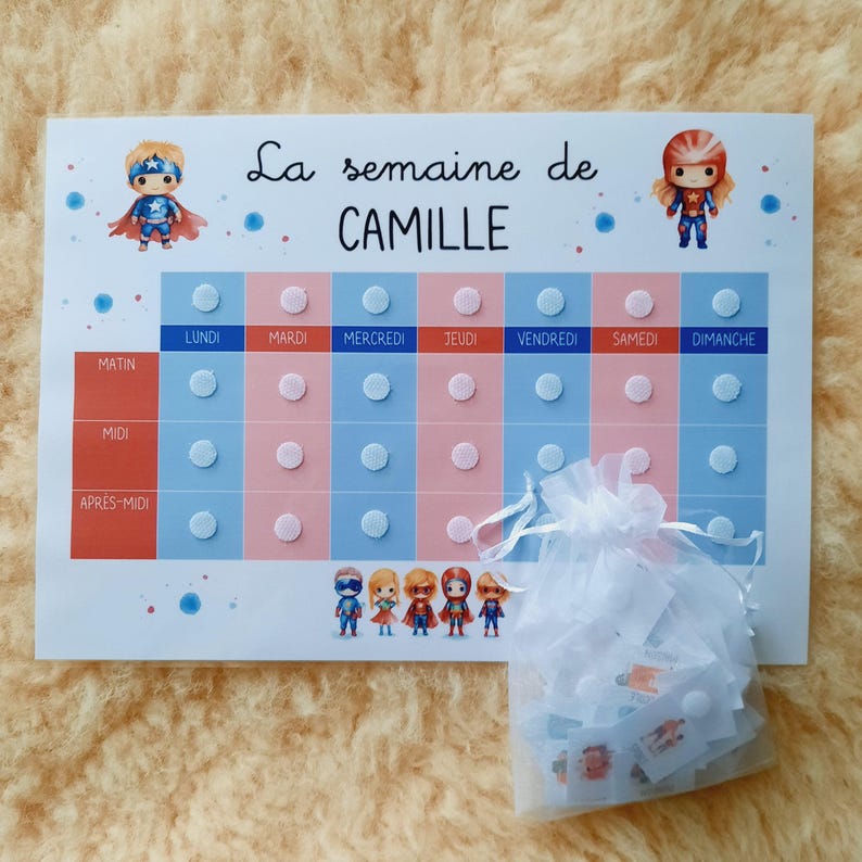 May include: A weekly chart for a child to track their daily activities. The chart is divided into morning, afternoon, and evening sections. Each day of the week is represented by a column with a superhero character at the top. The chart is printed on white paper with blue and pink accents. The chart includes the text "La semaine de CAMILLE".