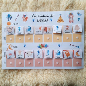 May include: A colorful chart with a daily routine for a child named Andrea. The chart has two sections: morning and evening. Each section has a list of activities with corresponding images. The chart is decorated with a woodland theme.