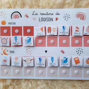 May include: A white printable chart with a pink and peach color scheme. The chart is titled "La routine de LOUISON" and has a daily routine for a child. The chart includes activities like getting dressed, brushing teeth, and reading a story.